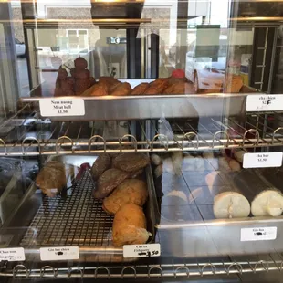 a variety of baked goods in a display case