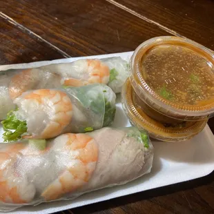 a plate of vietnamese food with dipping sauce