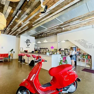 a red scooter in a coffee shop