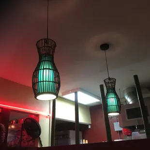 Red tube lighting with green lamp shades.