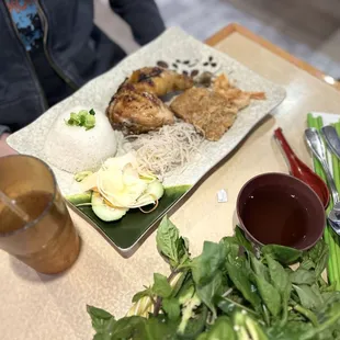 a person sitting at a table with a plate of food