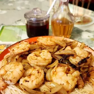 a plate of shrimp and noodles
