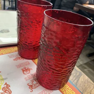two red glasses on a table