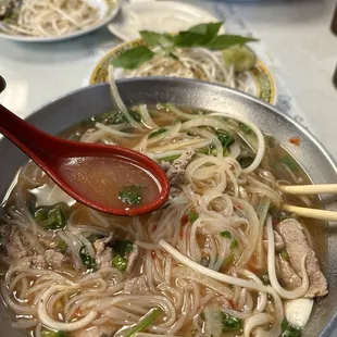 B1. Pho Tai : Beef Pho with onions, rice noodles, sliced beef, green onions, mint and cilantro