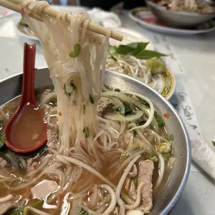 B1. Pho Tai : Beef Pho with onions, rice noodles, sliced beef, green onions, mint and cilantro