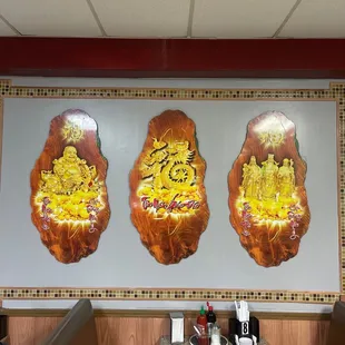 a wall with three asian food items on it