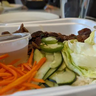 a tray of food with vegetables and meat