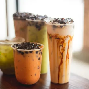 Front to back, left to right: tropical drink, Thai milk tea, Vietsubs milk tea, matcha milk tea, Okinawa milk tea