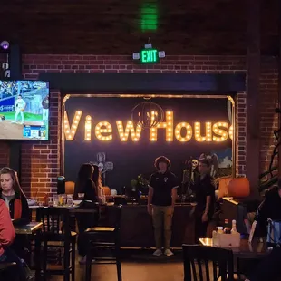 people sitting at tables in a bar