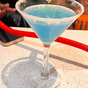 a blue martini in a martini glass