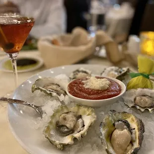 a plate of oysters and a glass of wine