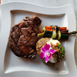 Rib eye medium rare, loaded potato, bundle of veg