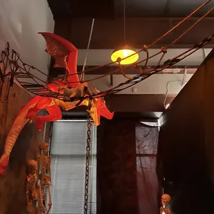 a red dragon suspended from a ceiling