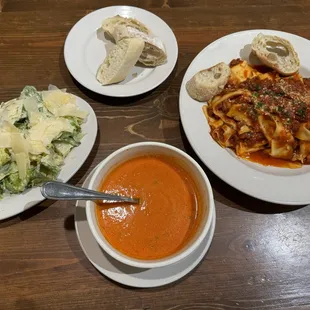 Caesar salad , creamy tomato basil soup, and Papardelle Bolognese