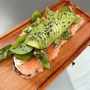 a sandwich with avocado and salmon