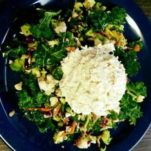 a blue plate with a salad on it