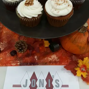 a tray of cupcakes with frosting