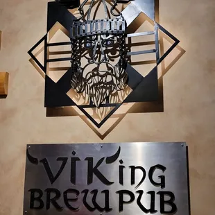 a metal sign with a viking head on it