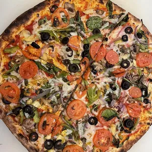 Veggie pizza, with vegan cheese plus artichoke hearts and basil.