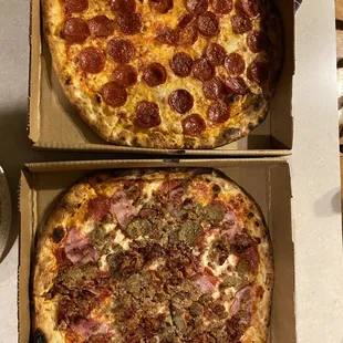 two pizzas in boxes