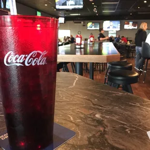 a glass of coke on a table
