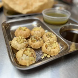 Pani Puri, plain looking, yet unexpected explosion of flavors once add tamarind chutney and pani water