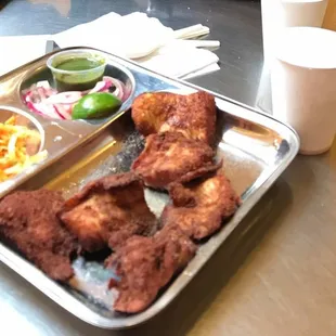 Fish koli wada with condiments (mint chutney and onions)!