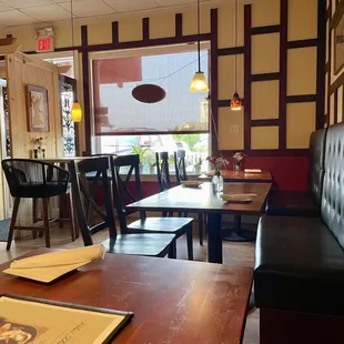 Interior of one side of restaurant - super small place, charming, neat and clean - booths, half booths, tables