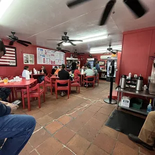 people sitting at tables in a restaurant