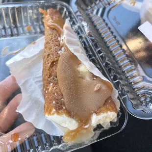 a hand holding a half eaten pastry