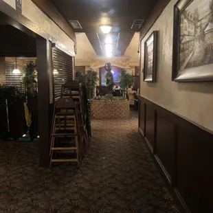Hallway looking up towards dining room. Cut out to left goes to bathroom and bar. Kitchen behind the wall on the right.