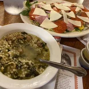 a bowl of soup and a plate of salad
