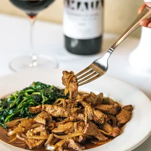 a plate of food and a glass of wine