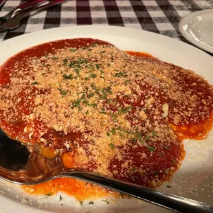 a plate of spaghetti sauce with a spoon