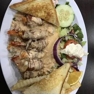 a plate of food with grilled bread and salad