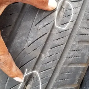 The mechanic show us where the spikes slash our tire the two white circle is where it got punctured..total ruined had to get brand new