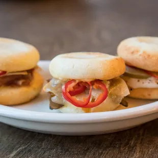 three sandwiches on a white plate