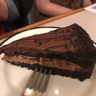 a slice of chocolate cake on a plate with a fork