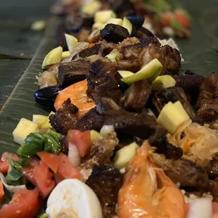 a long line of food on a banana leaf