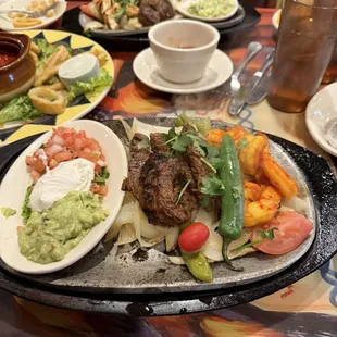 Steak and shrimp fajita and steak and chicken fajita. Steak was cooked perfectly to medium rare.