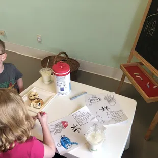 Kids corner with chalk board and coloring supplies