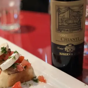 a plate of food and a bottle of wine