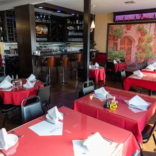 a restaurant with red tables and chairs