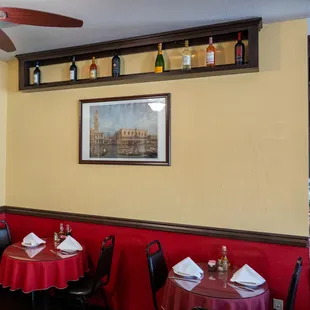a dining area with red tablecloths and red tablecloths