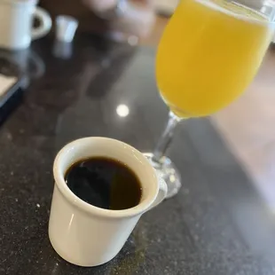 a cup of coffee and a glass of orange juice