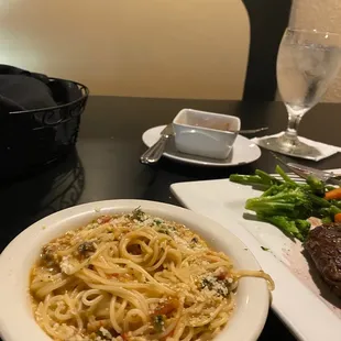 a plate of pasta with meat and vegetables