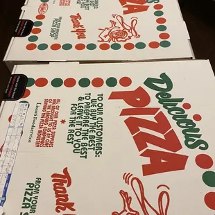 three boxes of pizza sitting on a table