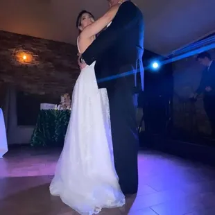 a bride and groom having their first dance