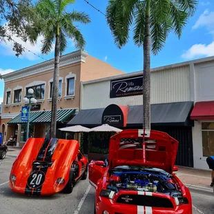 two exotic cars parked in a parking lot