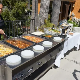 a woman preparing a buffet
